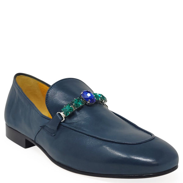 Blue loafer with gemstone embellishments on a white background
