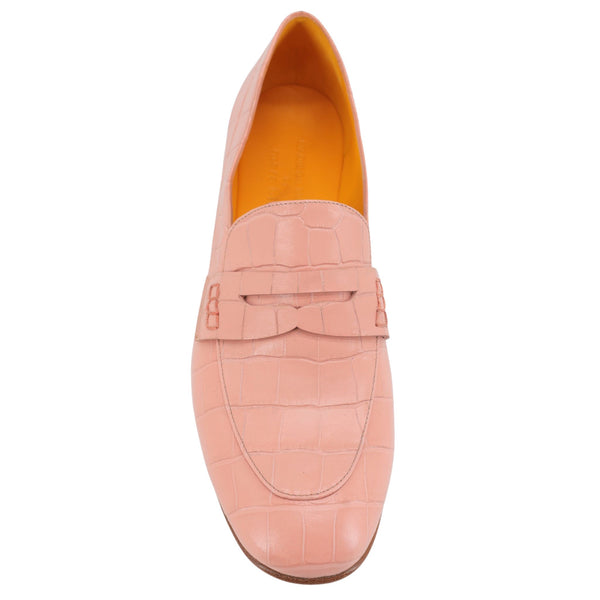 Pink loafer shoe with a textured finish on a white background