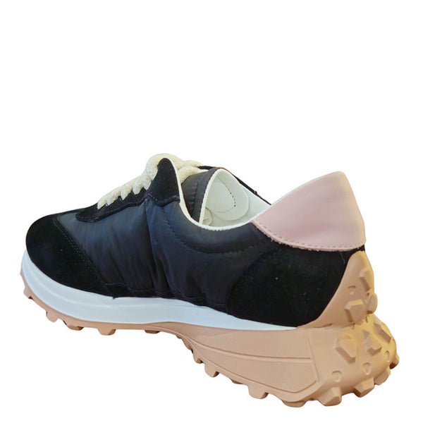 Navy and pink sneaker with a white sole on a white background