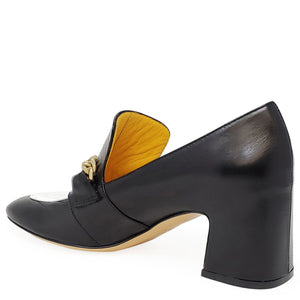 Black shoe with gold buckle and wooden sole on a white background