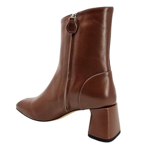 Brown leather boot with a block heel on a white background