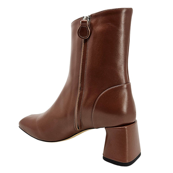 Brown leather boot with a block heel on a white background