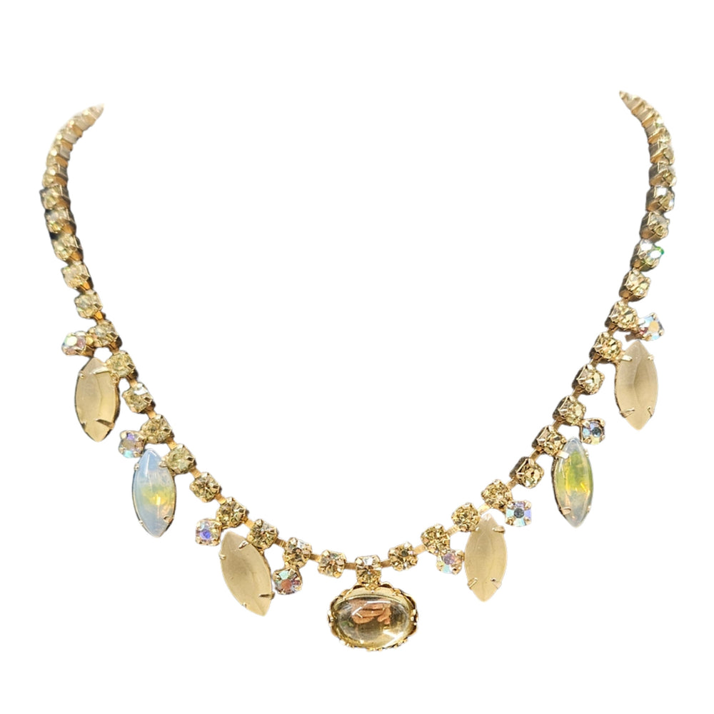 Gold necklace with gemstones on a white background