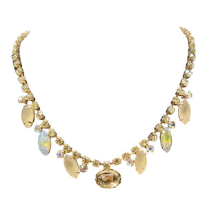 Gold necklace with gemstones on a white background