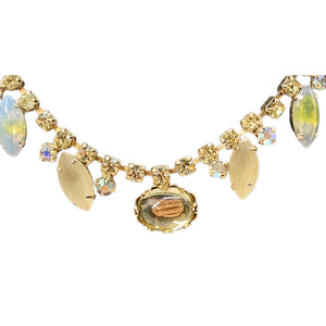 Gold necklace with gemstones on a white background