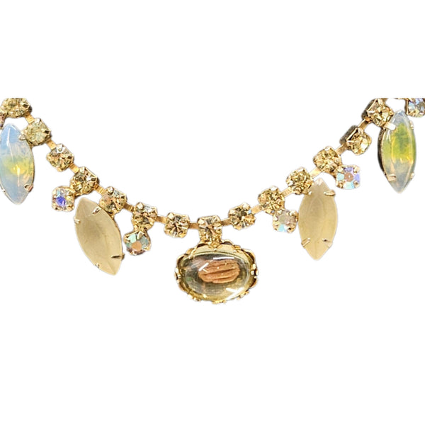 Gold necklace with gemstones on a white background