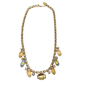 Necklace with yellow beads and gold accents on a white background