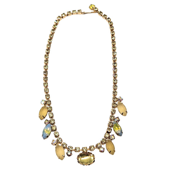 Necklace with yellow beads and gold accents on a white background
