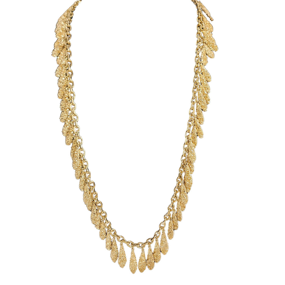 Gold necklace with multiple layers on a white background