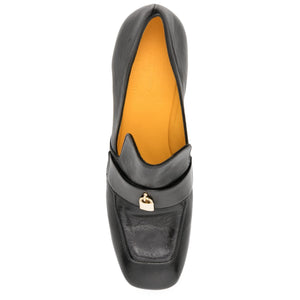 Black loafer shoe with gold heart detail on a white background