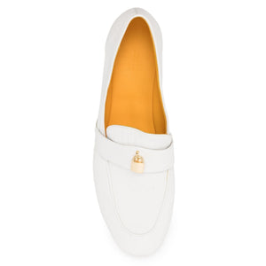 White loafer shoe with a gold tag on a white background