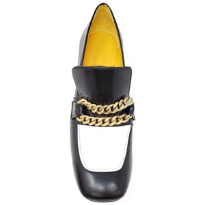 Black shoe with gold chain detail on a white background