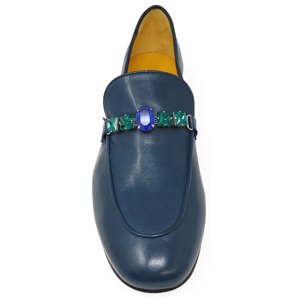 Blue loafer with a decorative brooch on a white background