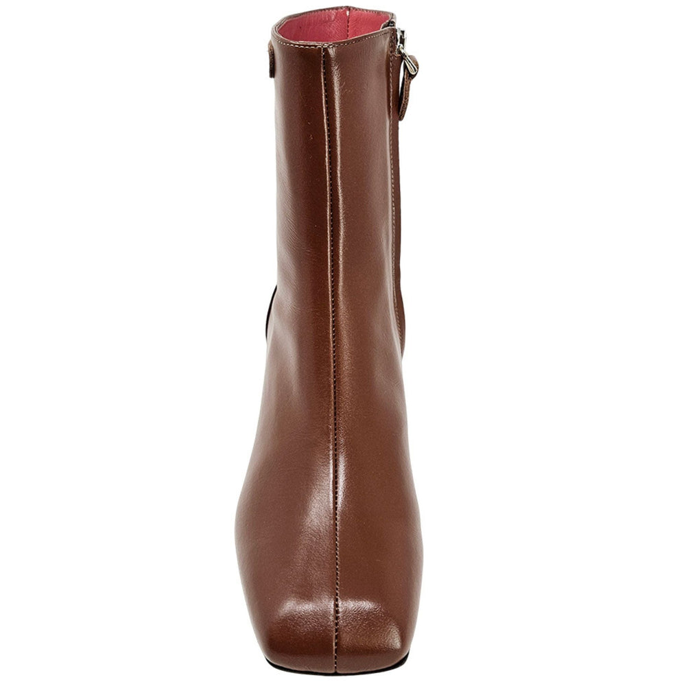 Brown leather ankle boot with chunky heel and strap with metal eyelets at top.