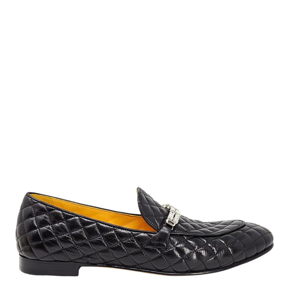 Black quilted loafer with a yellow interior on a white background