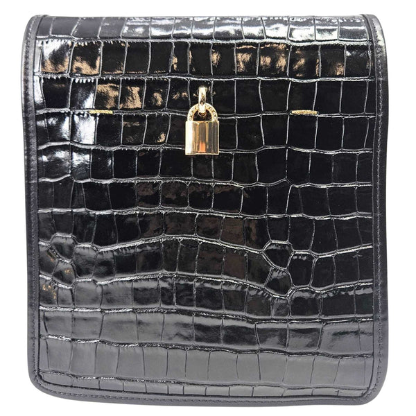 Black crocodile-patterned clutch bag with a gold lock on a white background