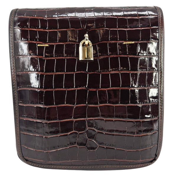 Brown crocodile-patterned clutch bag with a gold lock on a white background
