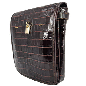Black crocodile-patterned handbag with a gold lock on a white background
