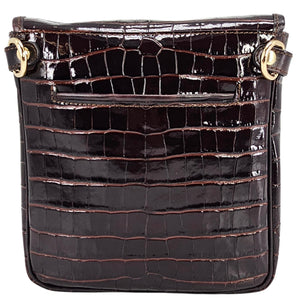 Black crocodile-patterned handbag with gold accents on a white background