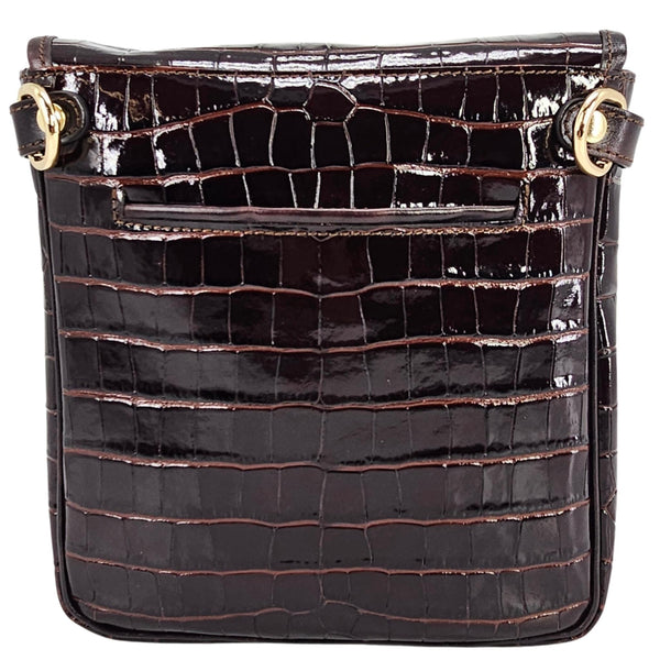 Black crocodile-patterned handbag with gold accents on a white background