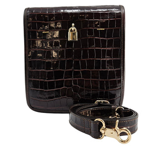 Black crocodile-patterned handbag with gold hardware on a white background