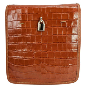 Brown crocodile-patterned leather bag with a silver lock on a white background