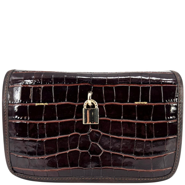 Brown crocodile-patterned clutch bag with a gold lock on a white background