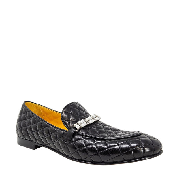 Black quilted loafer with a silver buckle on a white background