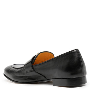 Black leather loafer with brown interior on a white background