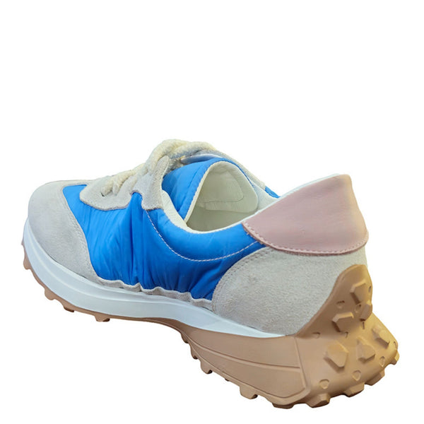 Multicolored sneaker with blue, beige, and pink accents on a white background
