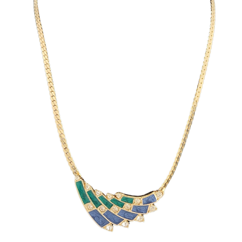Gold necklace with green and blue pendant on a white background