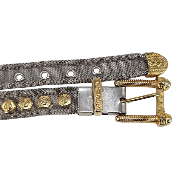 Metallic belt with gold accents on a white background
