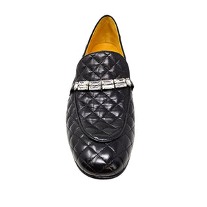 Black quilted loafer with decorative band on a white background