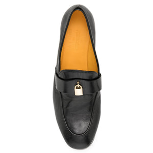 Black loafer shoe with gold buckle on a white background