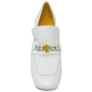 White shoe with a decorative band featuring a yellow gemstone on a white background