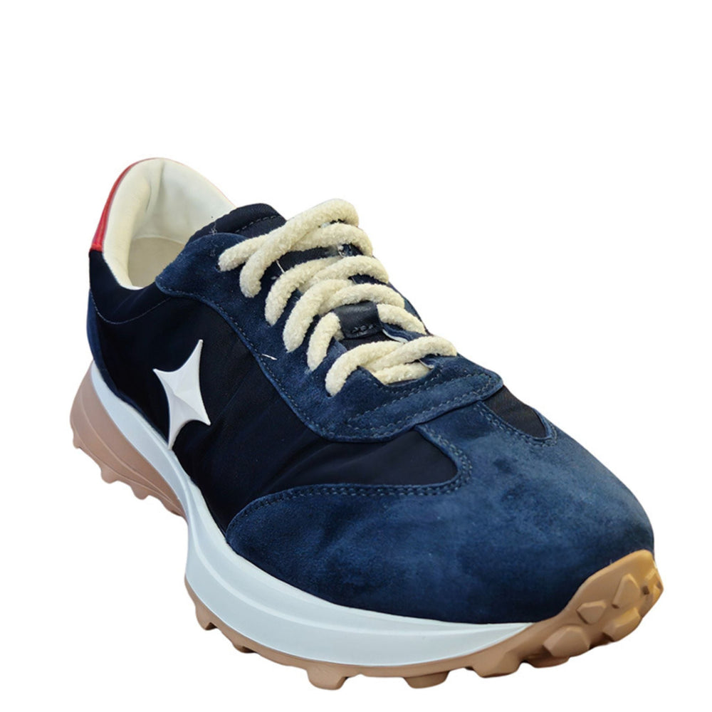 Navy suede jogger sneaker with white star logo, cream laces, red heel tab, tan sole