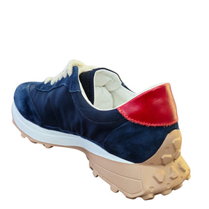 Blue sneaker with red heel and beige sole on a white background