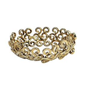 Gold bracelet with intricate design on a white background