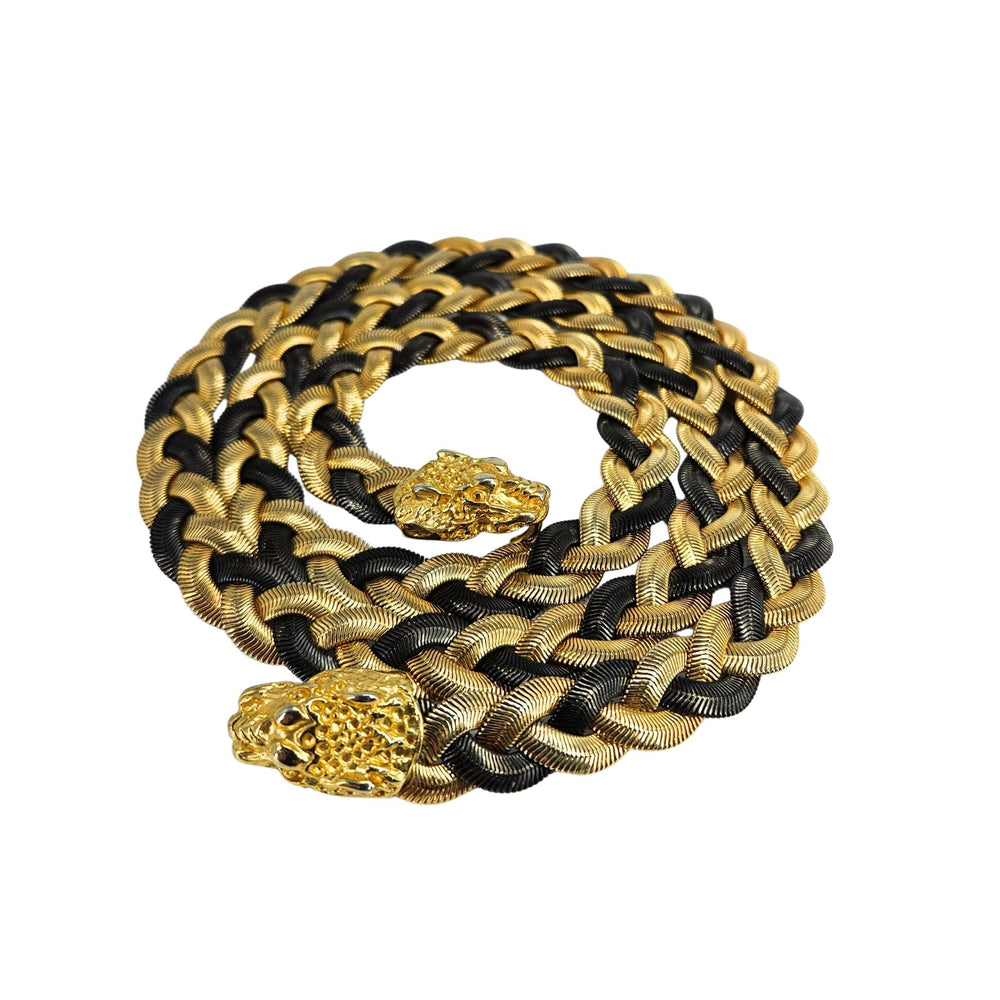 Gold and black braided necklace with panther head designs on a white background