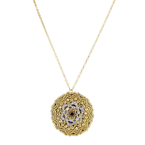 Gold necklace with a textured pendant on a white background
