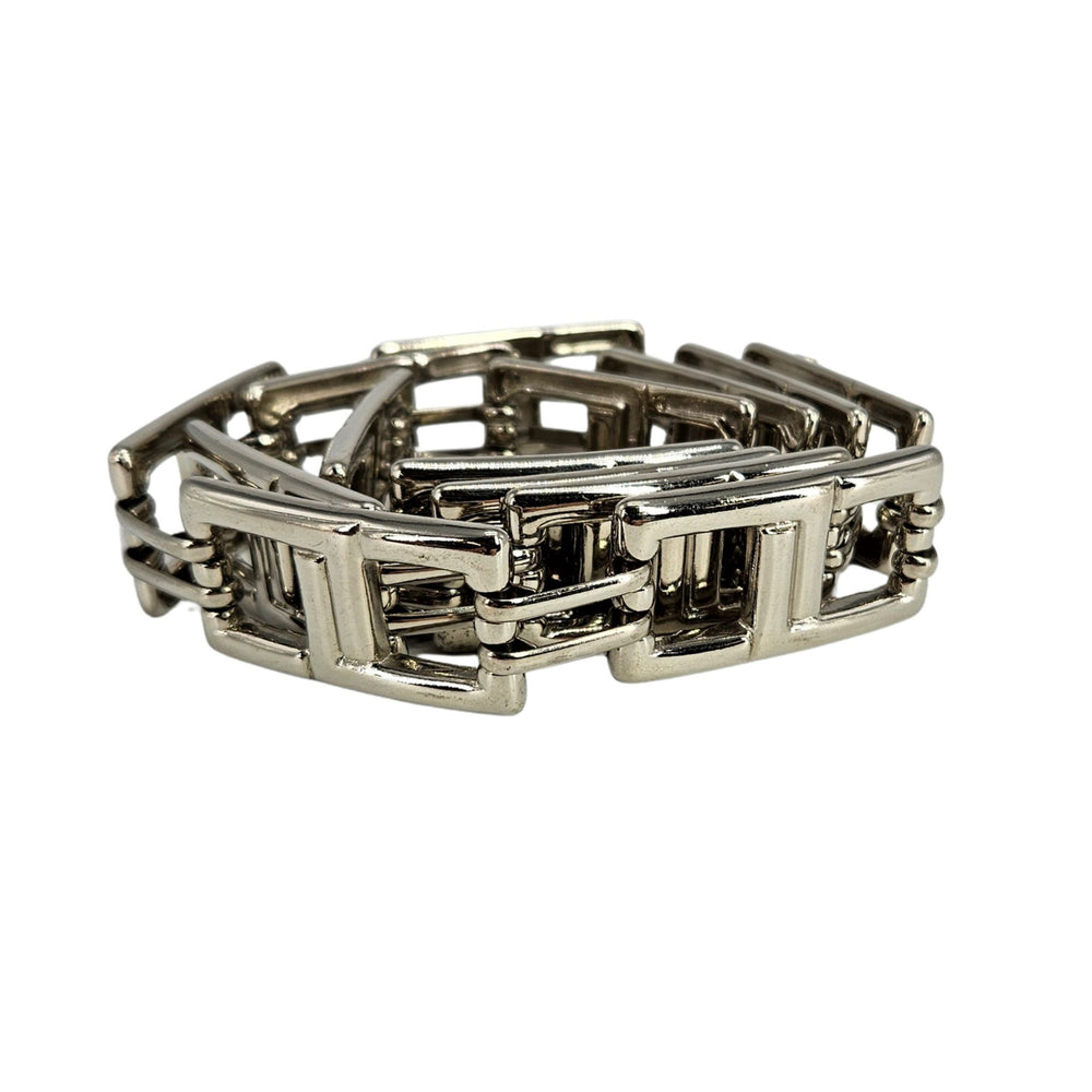 Silver bracelet with geometric design on a white background