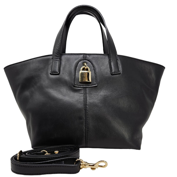 Black leather handbag with gold lock and matching strap on a white background