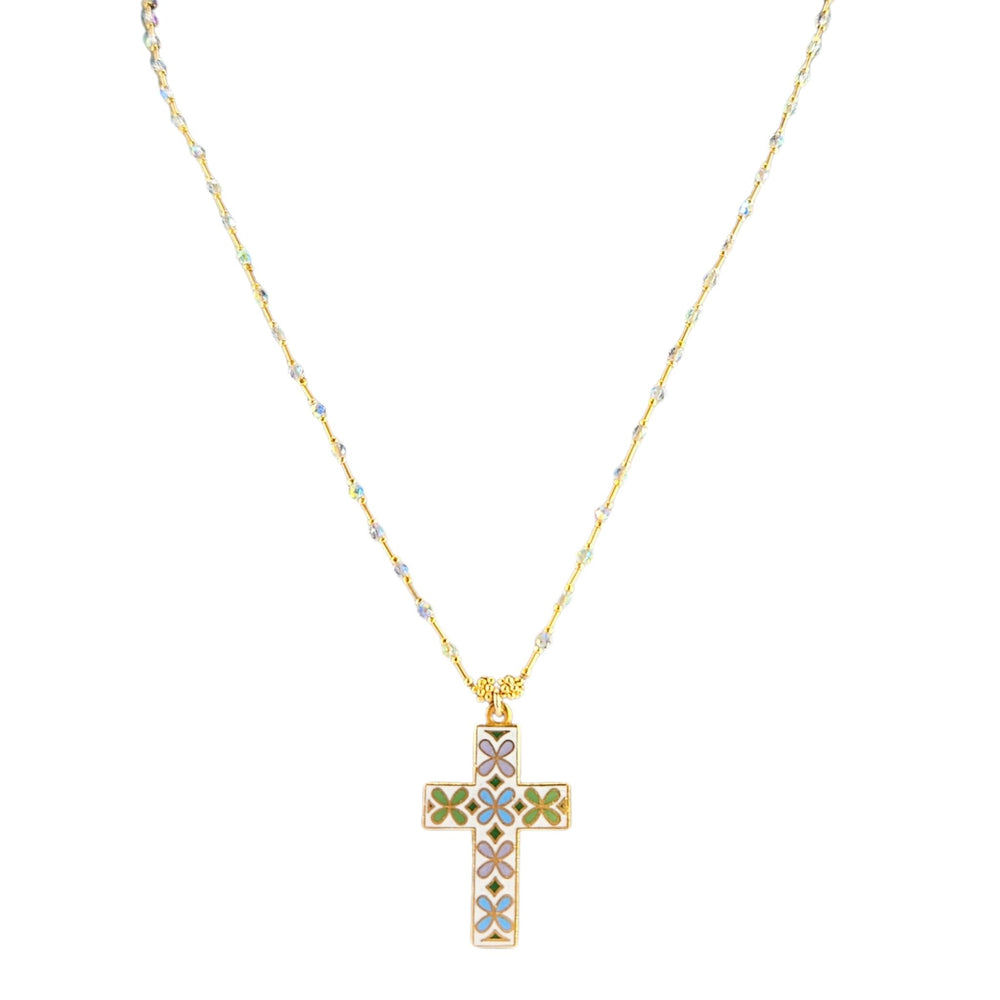 Gold necklace with a cross pendant featuring floral designs on a white background