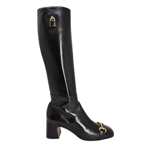 Black knee-high boot with gold accents on a white background