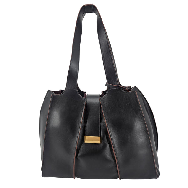 A sleek, black polished leather handbag with a wide opening, two top handles, and a horizontal gold bar accent on the front.