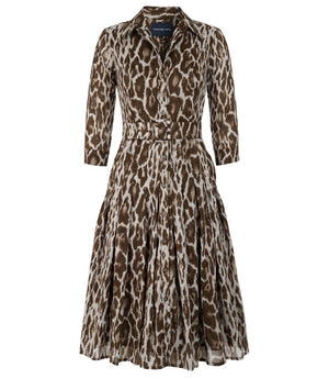 A knee-length dress with a collared neckline, three-quarter sleeves, and a flared skirt. Features a bold allover abstract pattern and fitted waist.