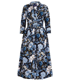 A knee-length dress with a collared neckline, three-quarter sleeves, and a flared skirt. Features a bold allover abstract pattern and fitted waist.