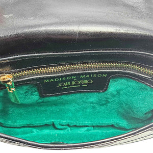 Close-up of a handbag with 'Joan Horne' branding on a green interior.