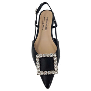 Black Italian leather slingback flat by Madison Maison with a pointed toe, low heel, and large rectangular crystal-embellished buckle on the front. Handcrafted in Italy with adjustable slim strap.
