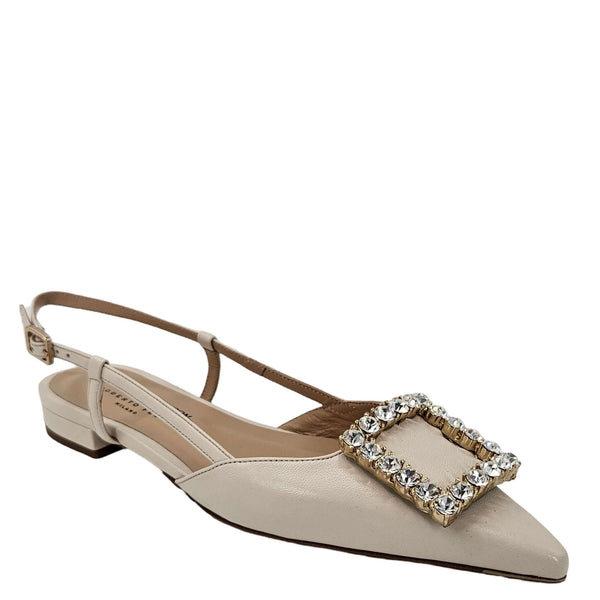 Beige flat shoe with a decorative buckle on a white background